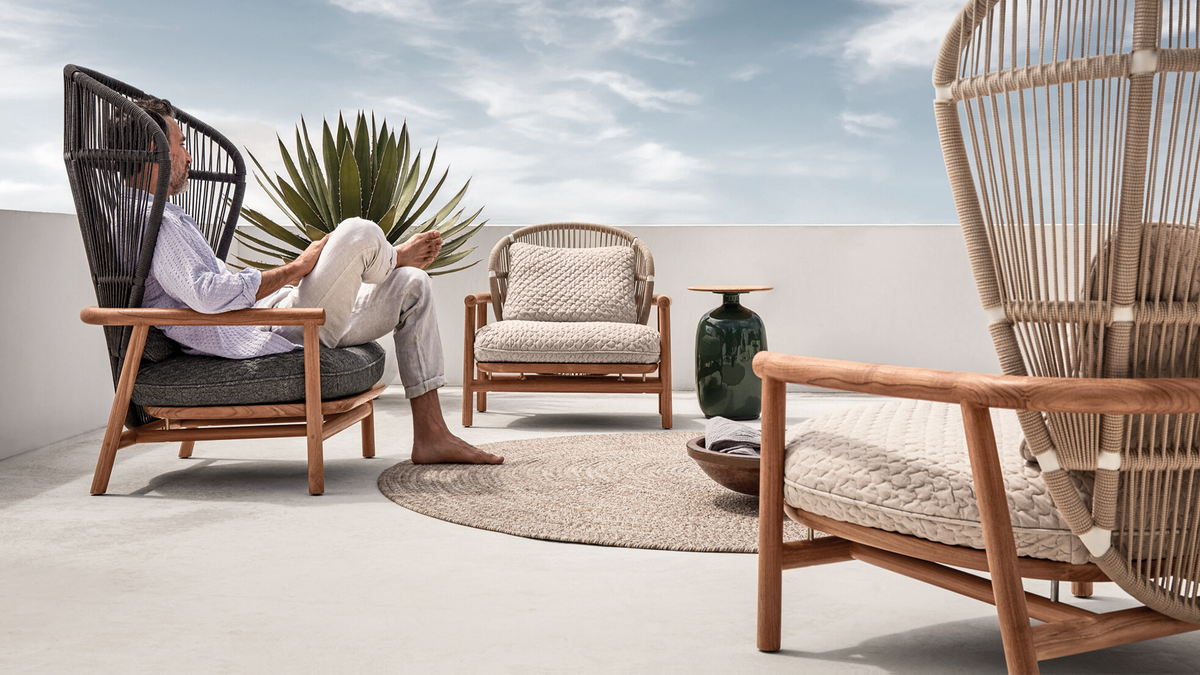 Gloster Fern outdoor furniture collection on walled patio
