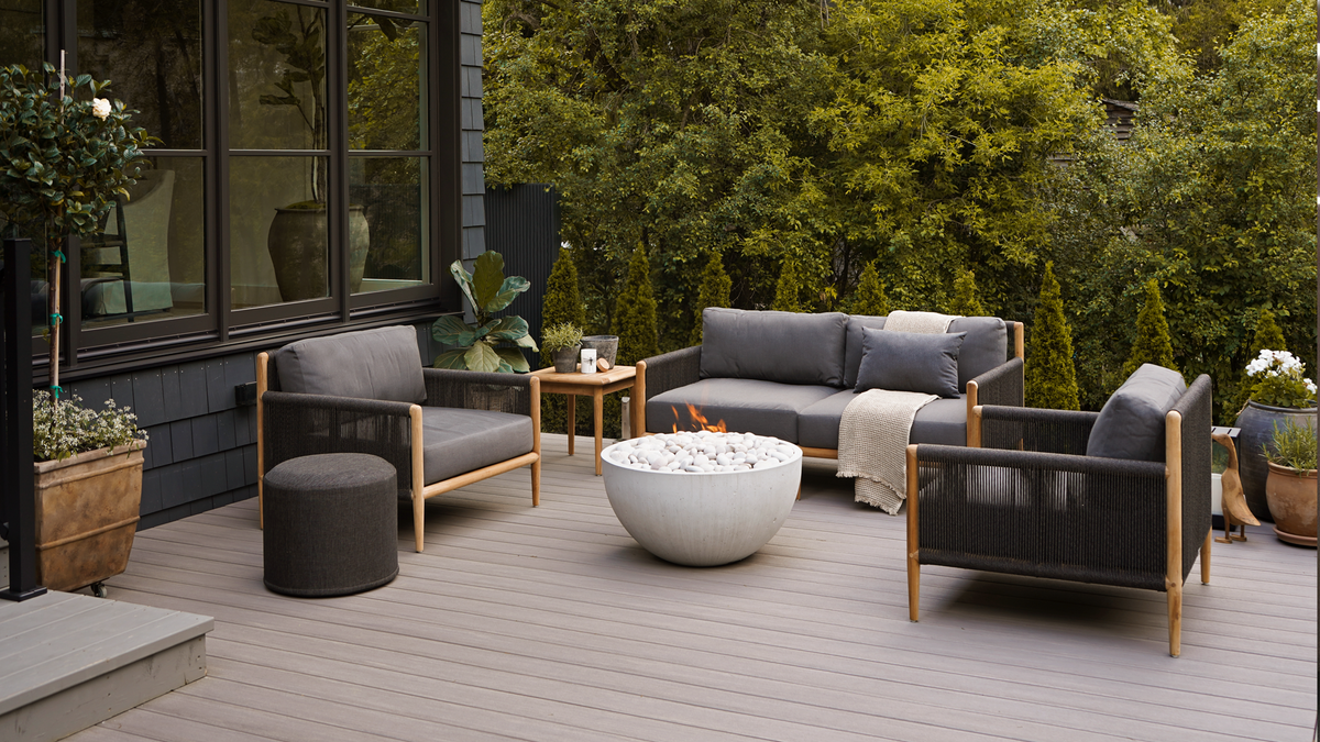teak outdoor lounge furniture with dark grey rope on patio
