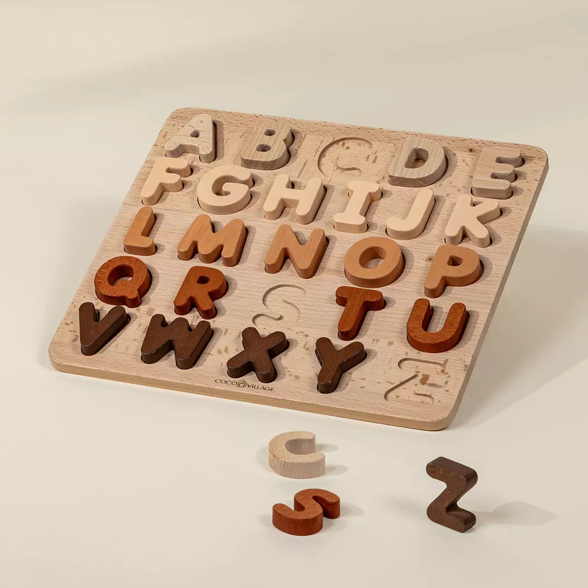 Wooden alphabet puzzle with letters on a beige background