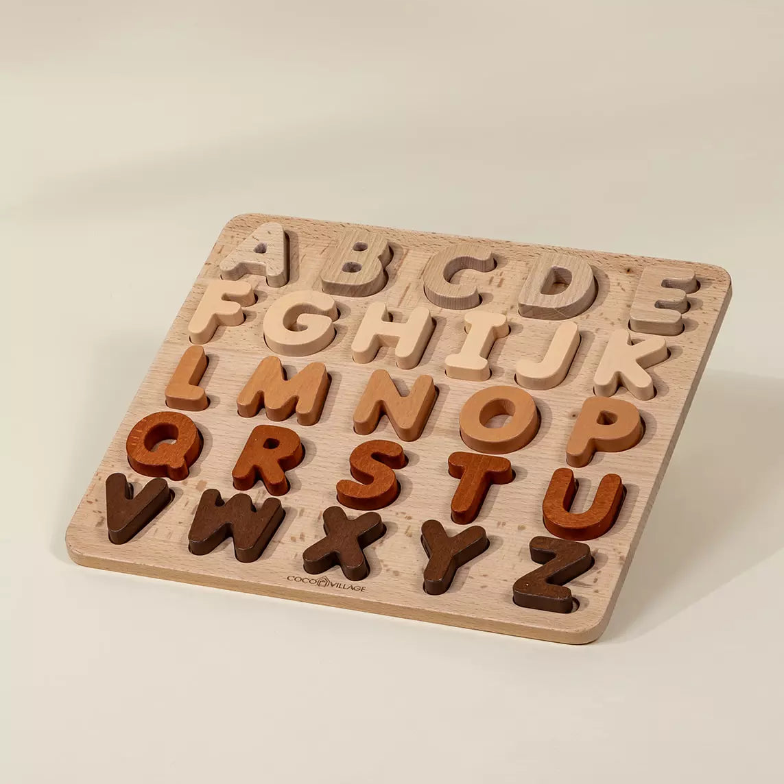 Wooden alphabet puzzle with letters on a beige background