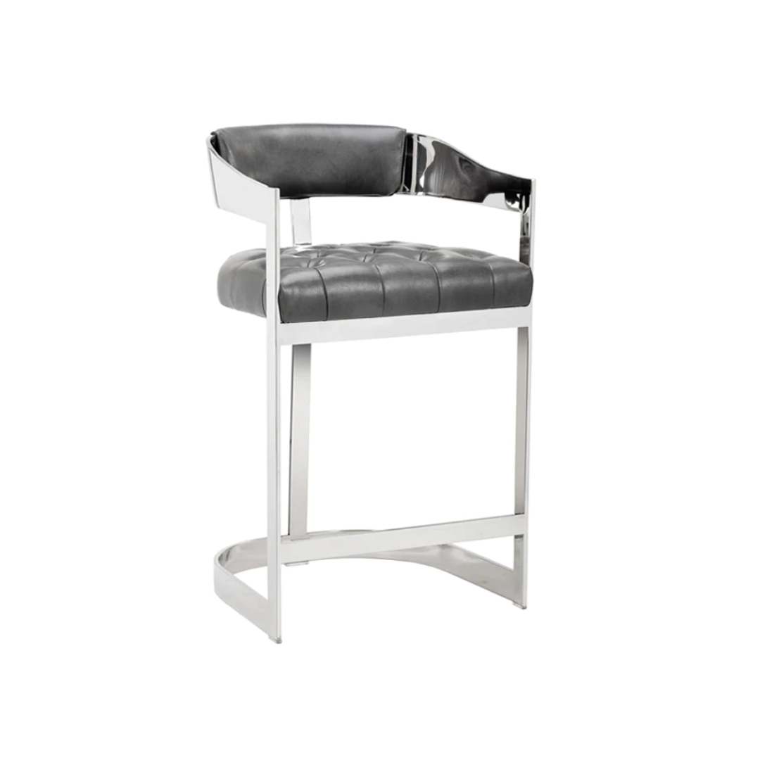 Premium contemporary indoor counter/bar stool, curved back with grey upholstered faux leather back rest detail, tufted grey faux leather seat, open arm rests, polished stainless steel legs in sleek straight design with curved base joining them, back leg that runs along from centre of back rest to ground