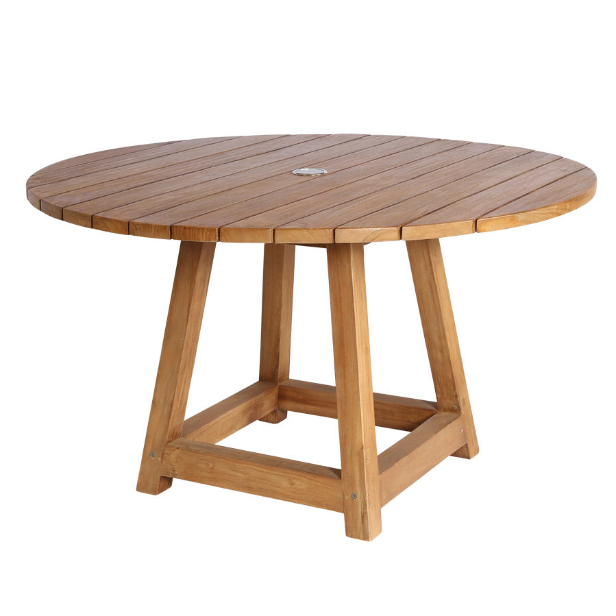Premium transitional indoor/outdoor round teak dining table, modern farmhouse style, braces at end and teak beams along bottom joining legs, slatted table top, umbrella hole in center, chunky legs