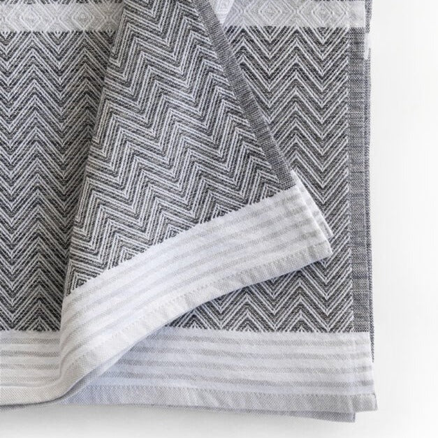 Premium one of kind cotton hand towel, intricate chevron pattern in warm charcoal and white with white and grey striped band at edge
