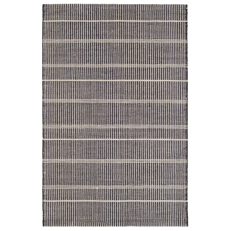 Premium indoor and outdoor rug, hand crafted in PET material. A mix of vertical black stripes and horizonal cream stripes, that is reversible. Lightweight, low rug pile with soft texture.