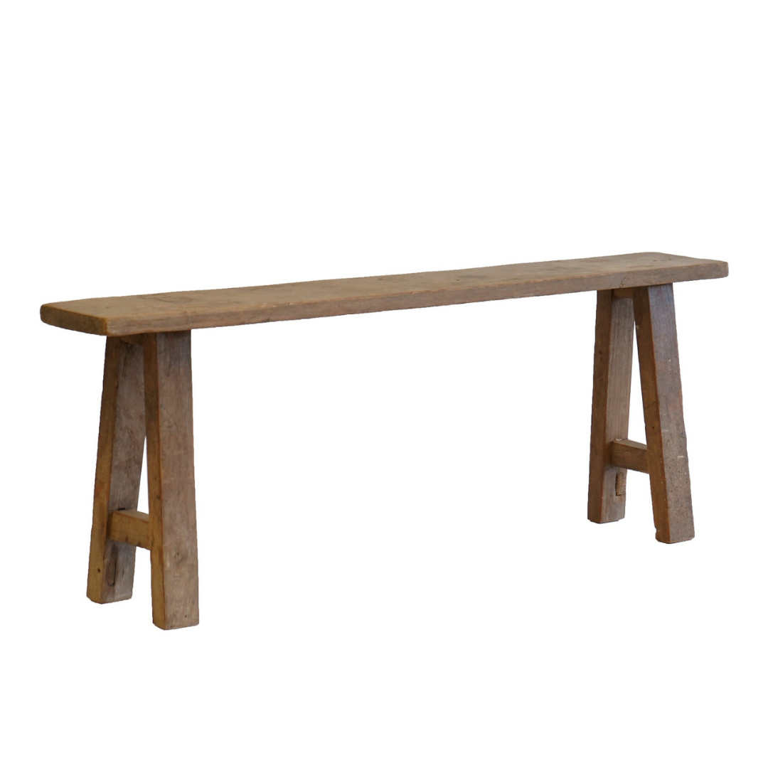 Premium indoor and outdoor bench in a nutty-brown wood colour. The rectangular top perches on 4 rectangular legs shaped like two A-letters.