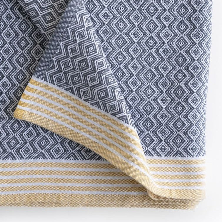 Premium one of kind cotton grey and white coloured hand towel, intricate geometric diamond pattern in grey and white and banded with white and yellow stripes at edge