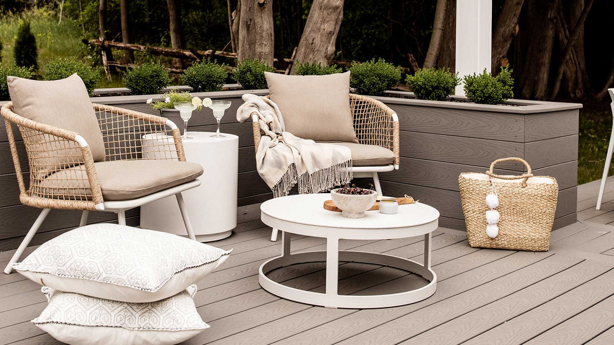Barrel teak table and rope chairs on poolside deck