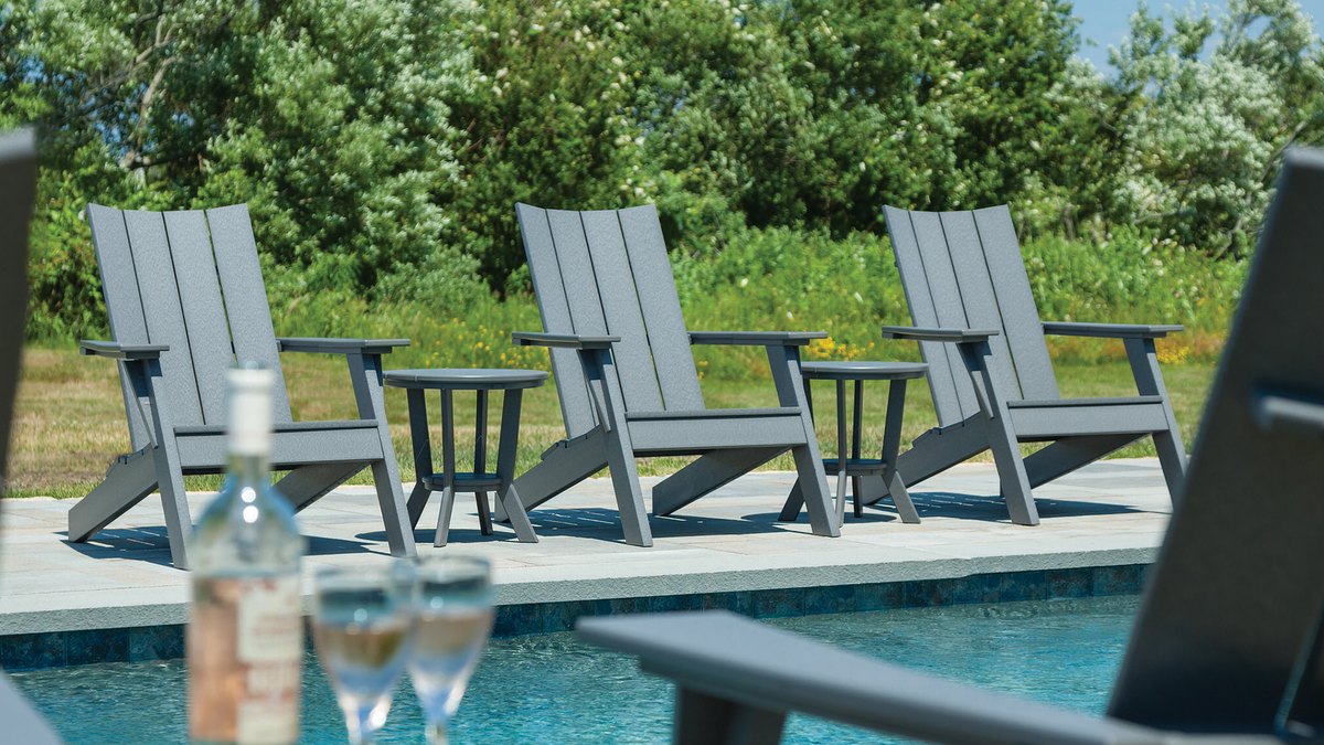 Dock chairs and side tables on poolside patio