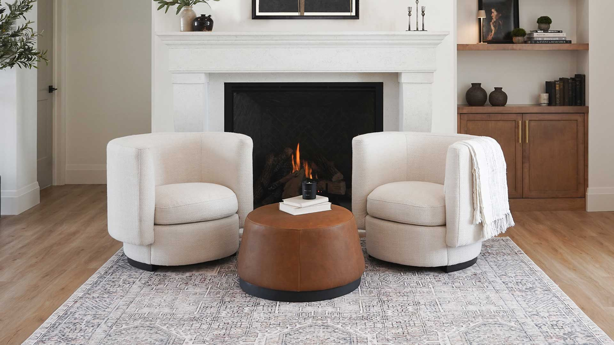 white modern barrel style lounge chairs in front of fire