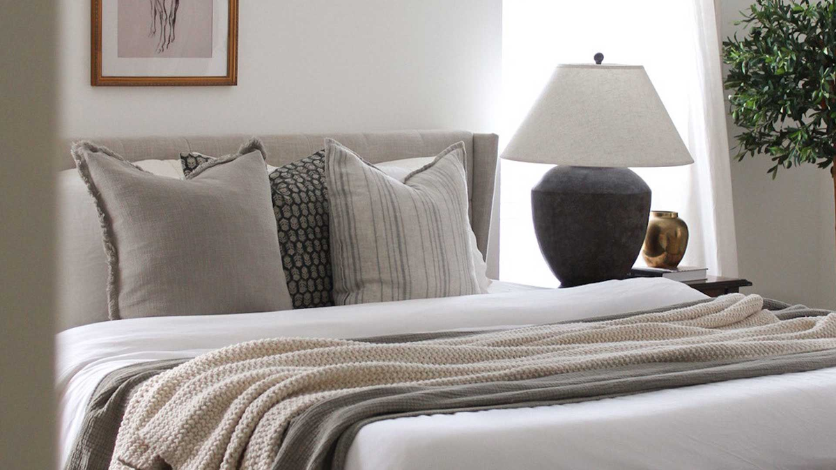 linen pillows and texture throw blanket on bed