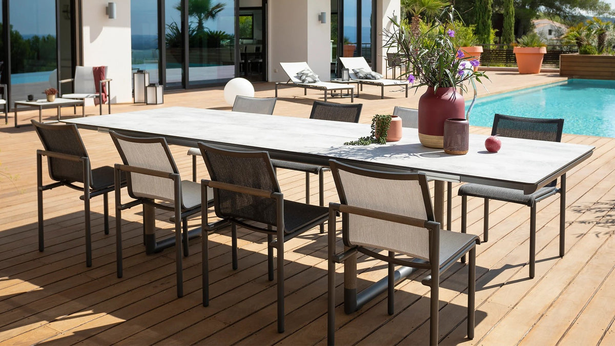 8 person outdoor dining table and chairs on wooden poolside deck