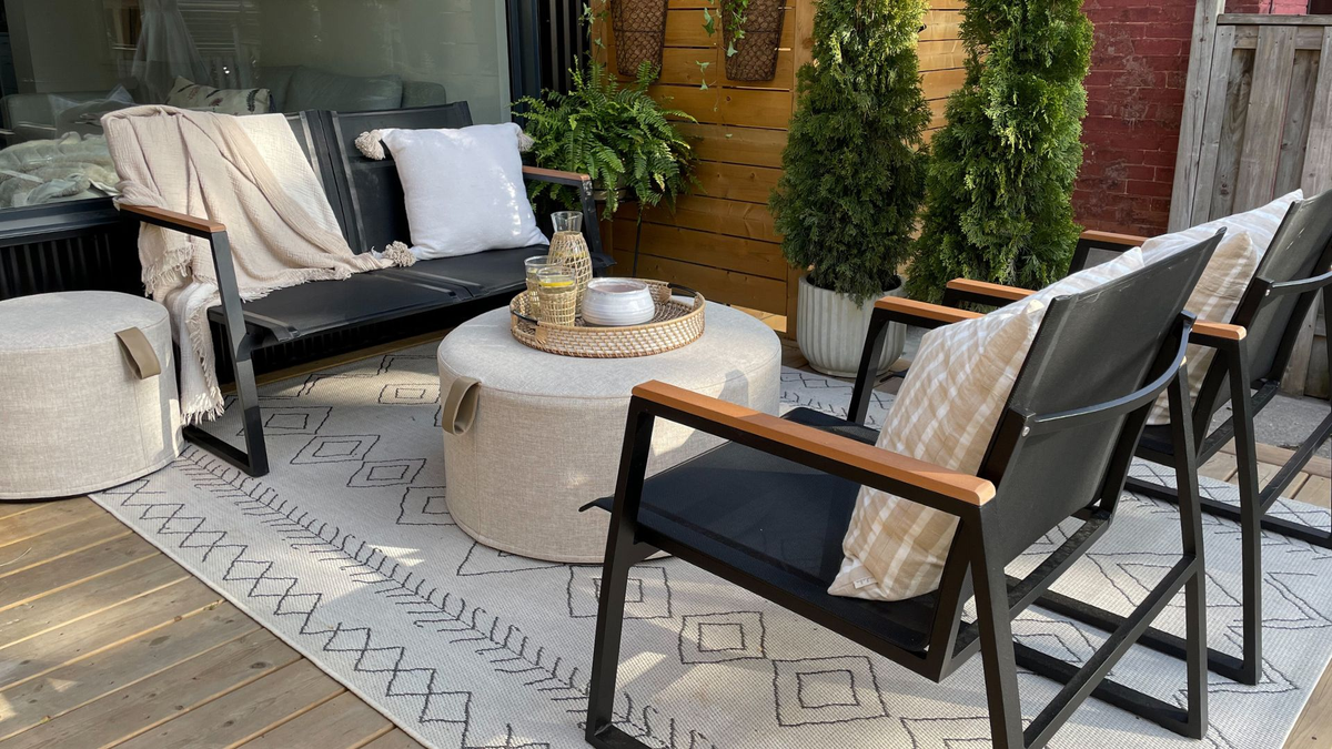 Small modern patio with black frame loveseat and chairs
