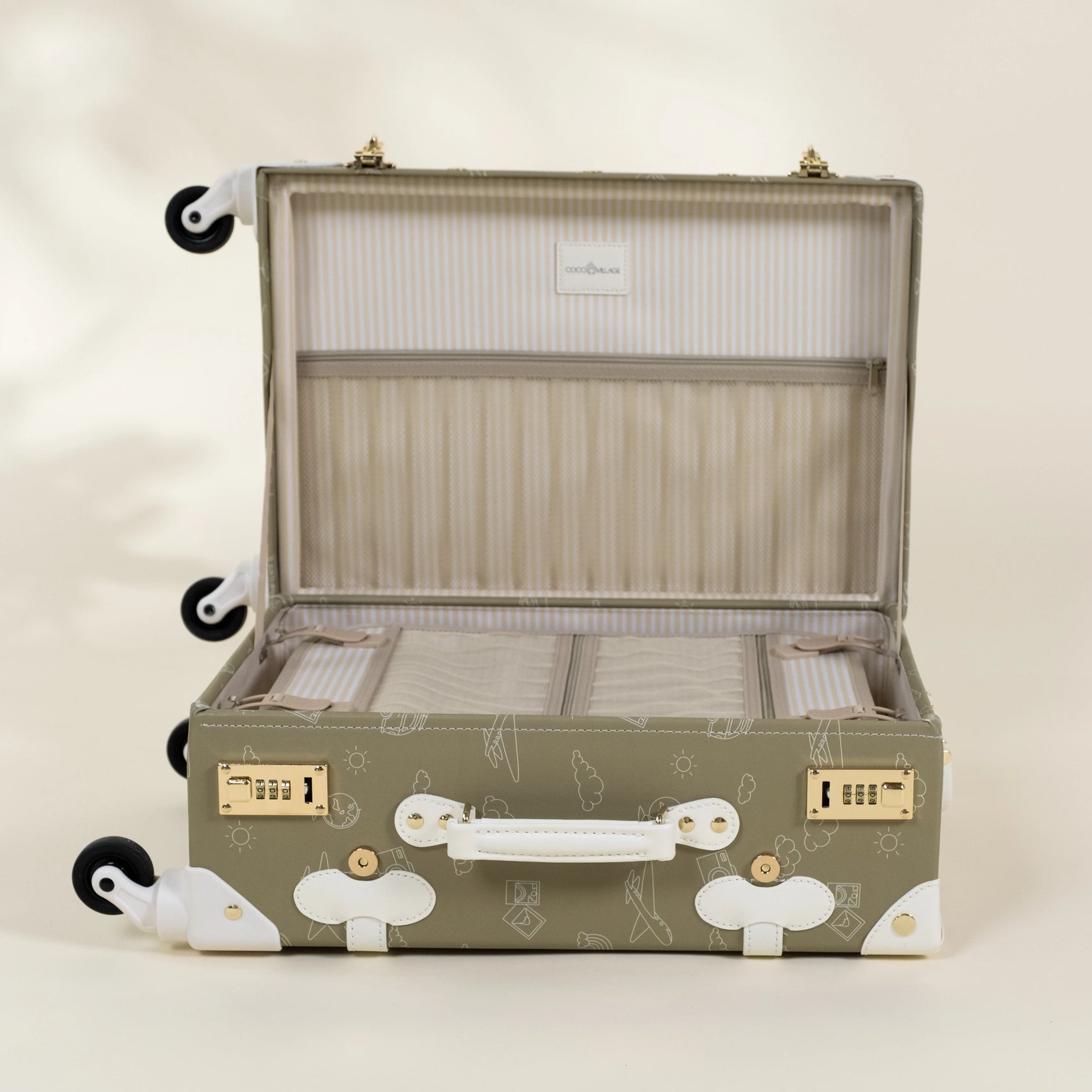 Green suitcase with white paw print design on a beige background