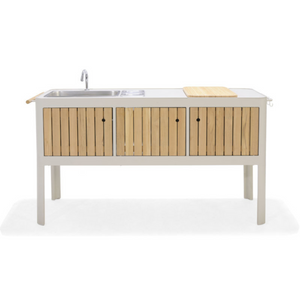 Premium outdoor kitchen, sand coloured frame, three teak vertical slatted front doors, curved corners, rectangular sink, contemporary faucet, teak towel holder bar, sand coloured bar with hooks at opposite side, loose teak cutting board/sink cover, two built-in removable condiment cubbies
