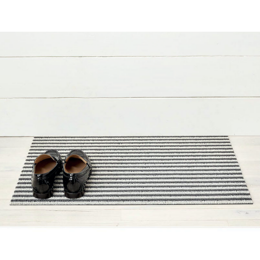 Premium indoor and outdoor doormat, made from tufted, looped vinyl yarns with a vinyl backing.  Narrow stripe pattern of light grey and black colours.  Doormat has a soft texture.