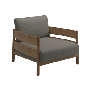 Gloster Haven outdoor teak lounge chair with wide side and back panels and Loom 3 Castlerock grey cushions