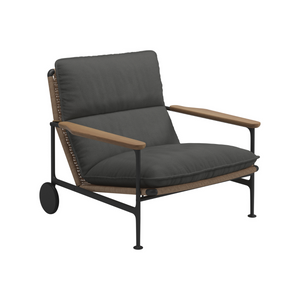 Gloster Zenith Lounge CHair with Arms in meteor grey tubular aluminum frame with wheat coloured modern wicker seat and wheels.