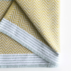 Premium one of kind cotton lemon coloured beach/bath towel,  intricate chevron pattern in warm yellow and banded with white and grey stripes at edge