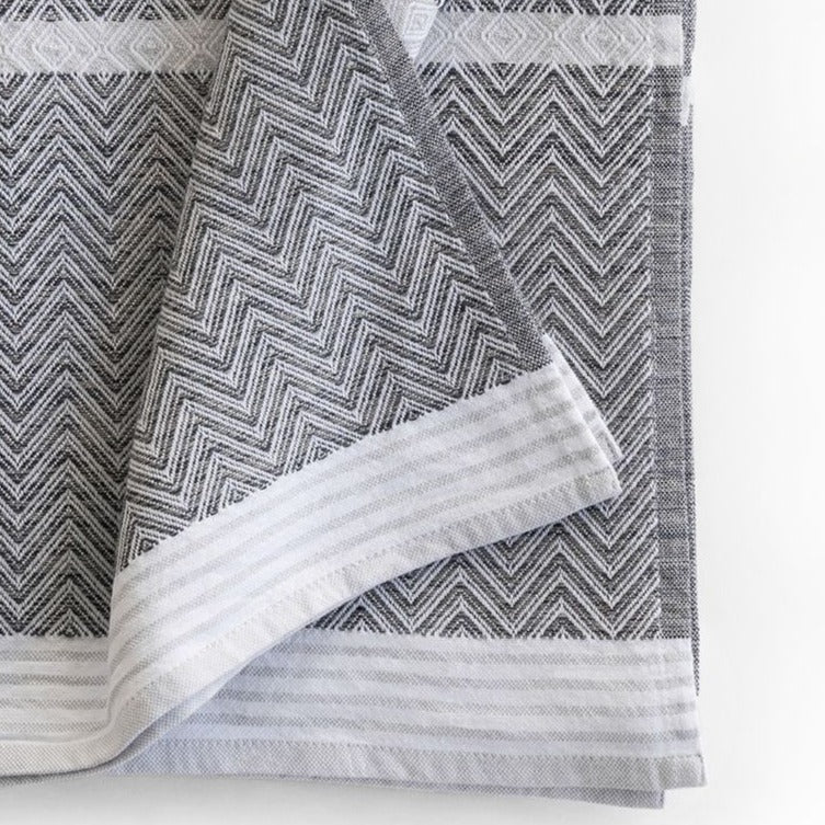 Premium one of kind cotton beach/bath towel,  intricate chevron pattern in warm grey and white with white band at edge and white stripes 